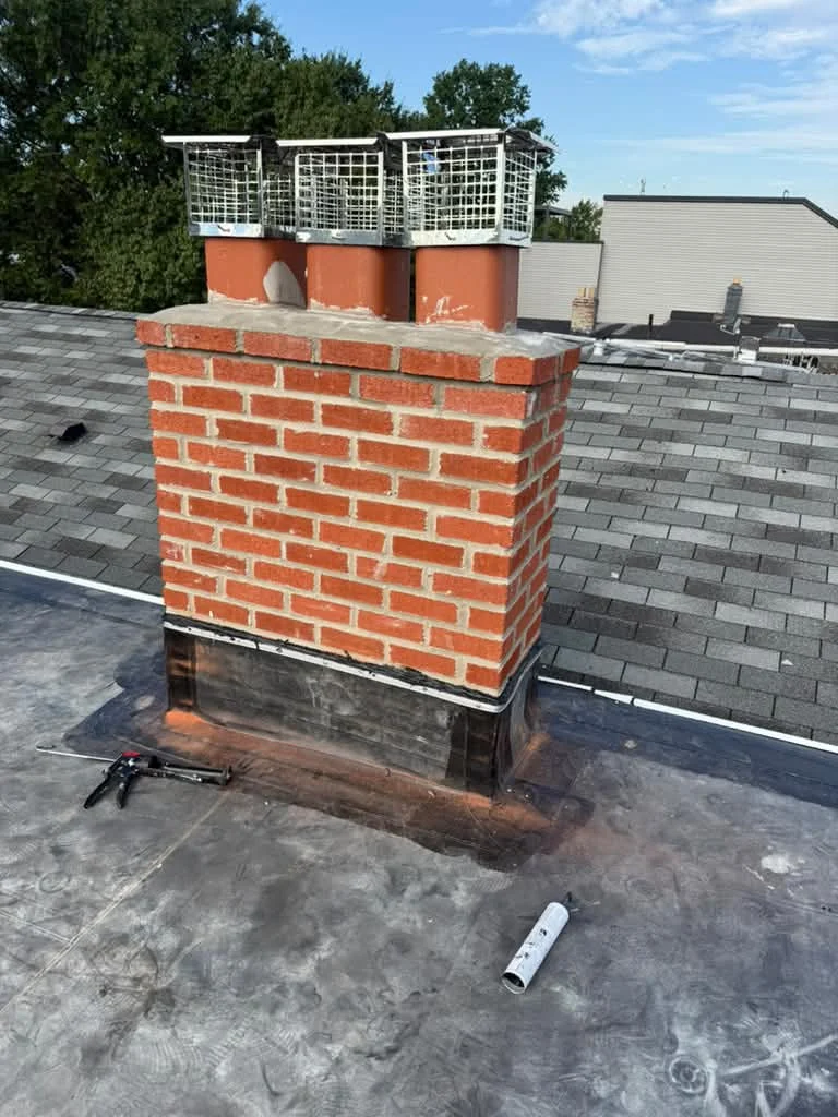 Existing chimney and aging roof surface before an EPDM flat roof replacement in Jersey City NJ