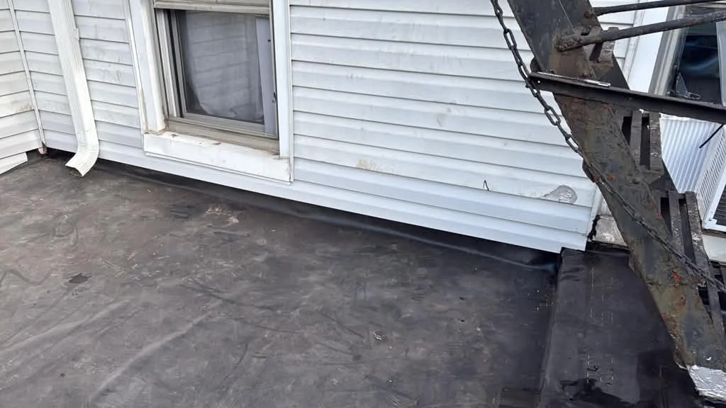 Existing roof edge and wall flashing area before replacement in Jersey City NJ