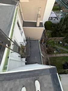 Completed black EPDM flat roof and chimney flashing in Jersey City NJ