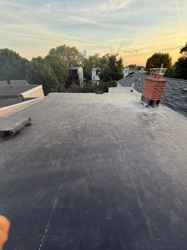 Completed EPDM membrane roof with sealed perimeter details in Jersey City NJ