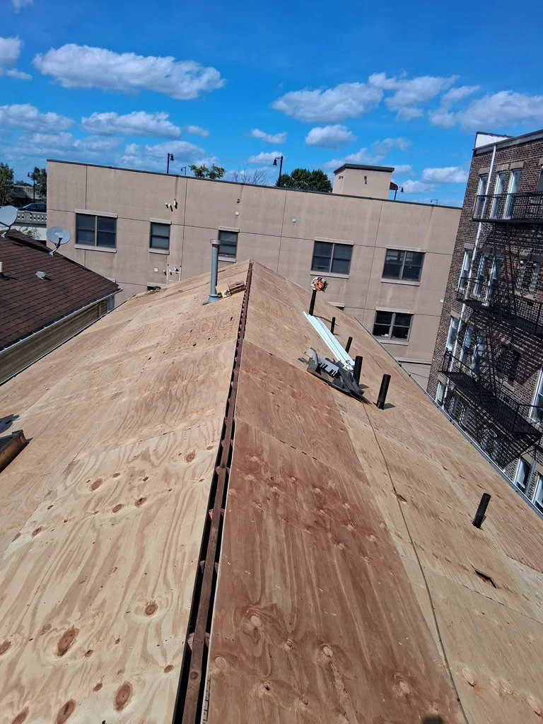 New plywood sheathing around roof penetrations during a Jersey City reroof