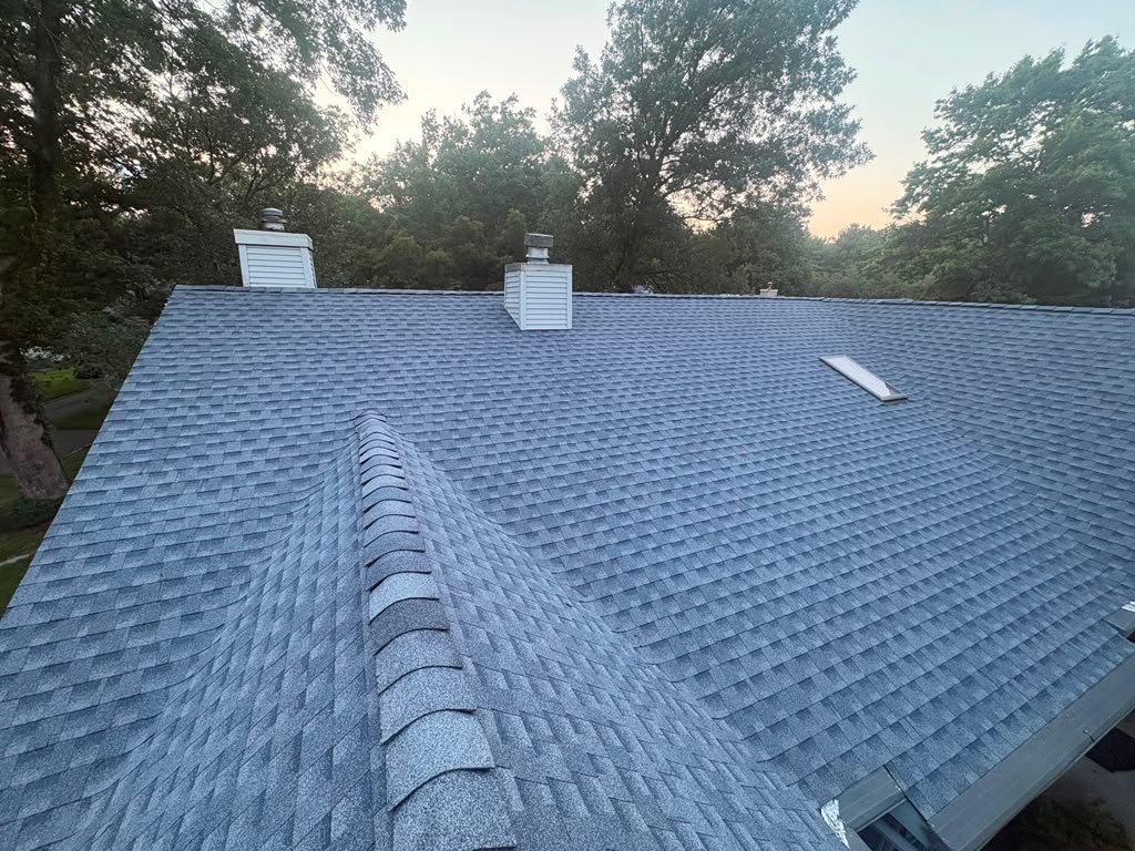Completed ridge and shingle installation on a Whiting residential roof