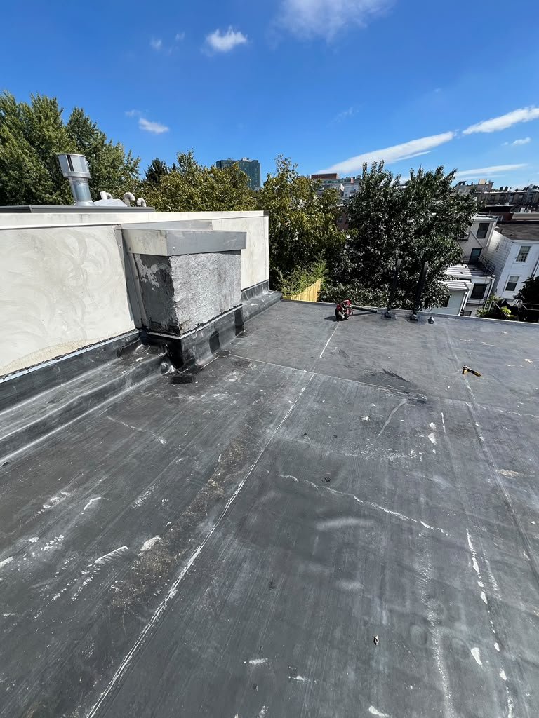 Completed black EPDM membrane and parapet flashing on a Hoboken NJ flat roof