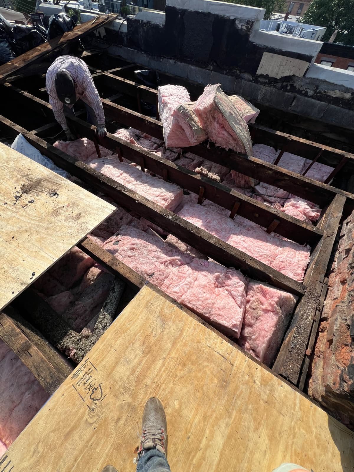 Open Hoboken NJ flat roof showing framing, insulation removal, and new plywood decking