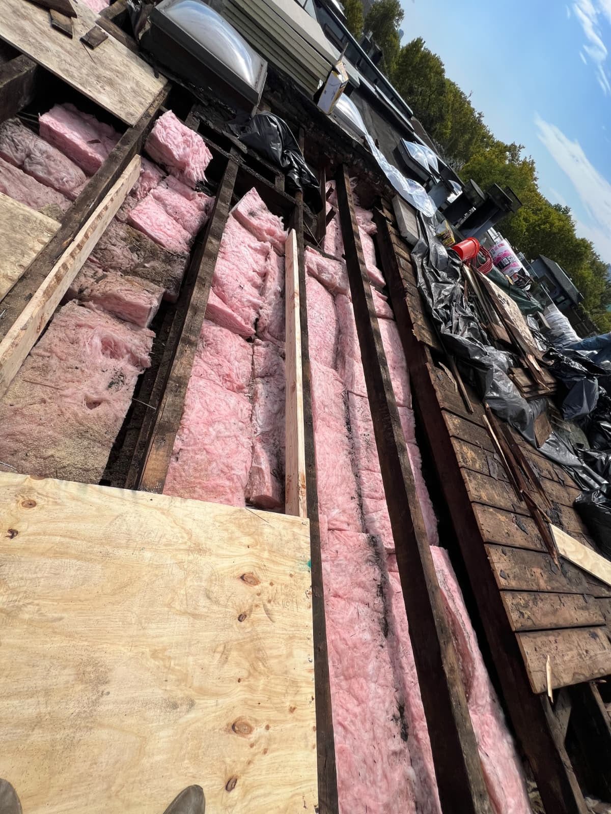 Open low-slope roof with skylights and damaged insulation during Hoboken NJ roof replacement