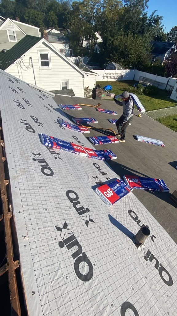 Fiberglass batt insulation positioned during a South Amboy roof replacement