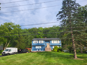 Finished shingle roof and blue vinyl siding exterior renovation in Westwood NJ
